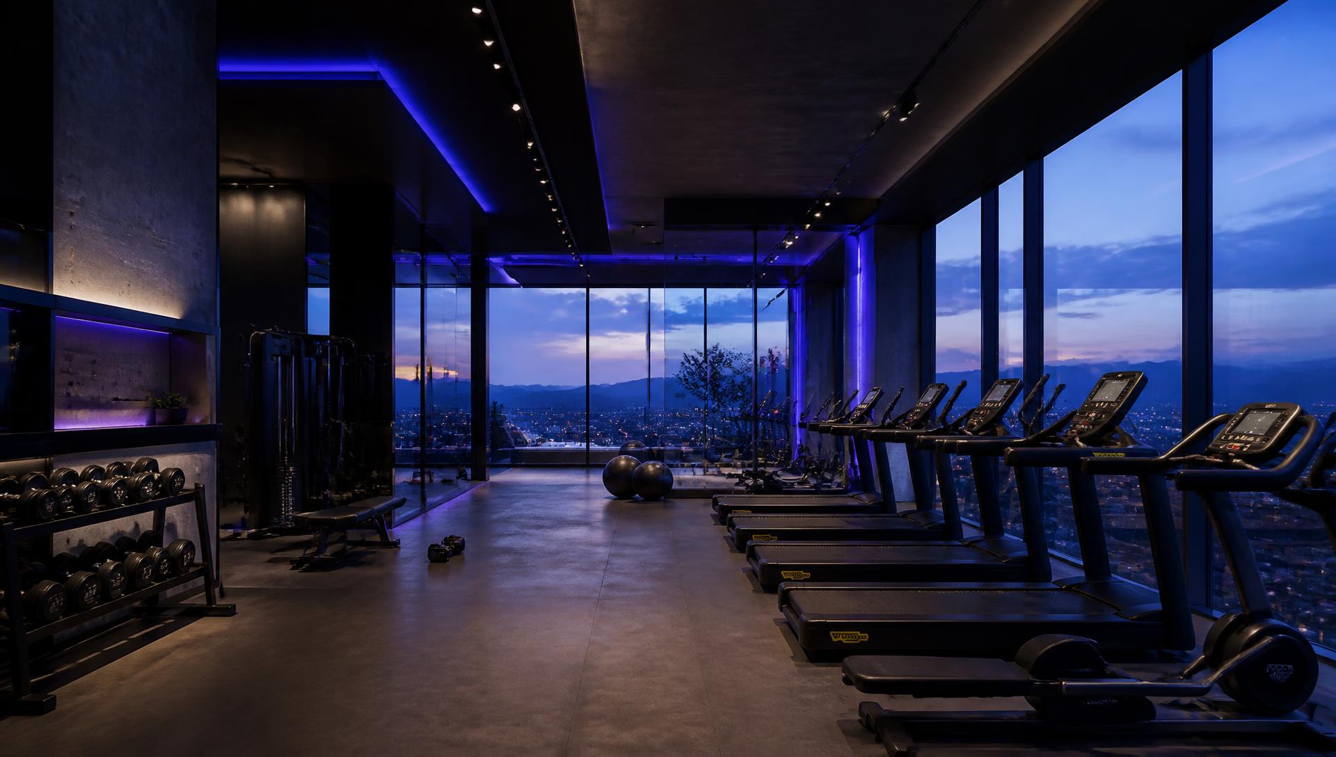 Academia condominial premium com arquitetura contemporânea e iluminação azul e roxa
